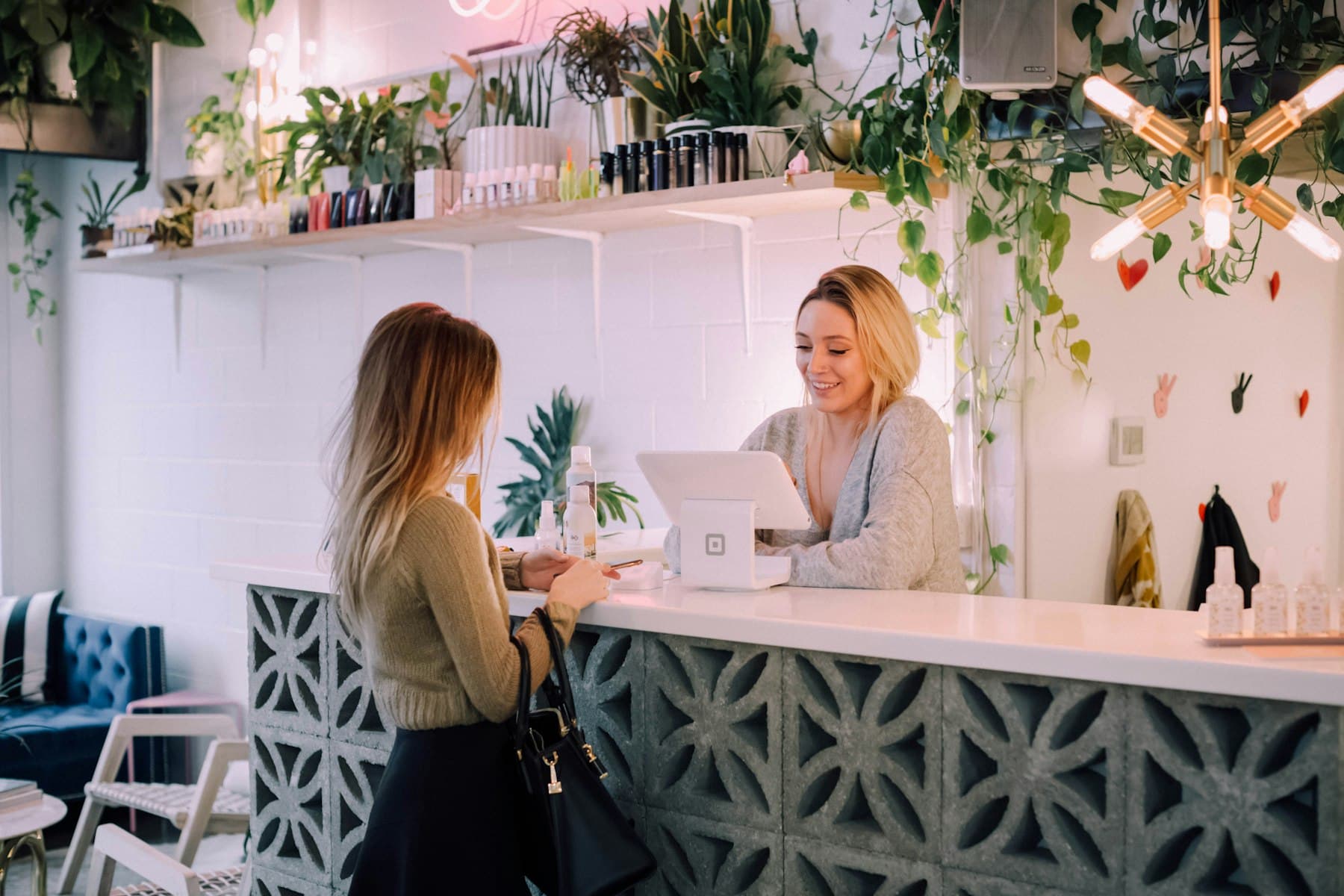 A customer paying at a bright café counter